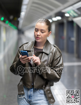 Girl standing at subway station. Woman looks at the metro map and checks where to transfer between stations