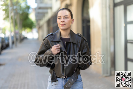 Young female tourist walks through a spring city and takes in sights