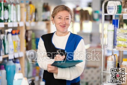 Adult woman seller conducting inventory in store