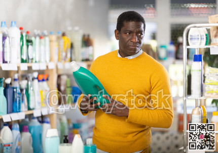 Male consumer with household chemical products for washing indoors