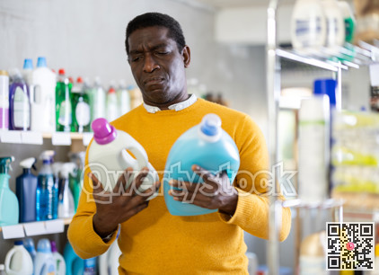 Male consumer with household chemical products for washing indoors