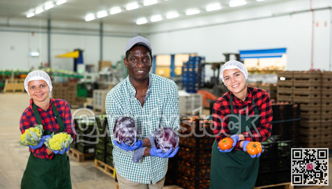 Vegetable factory workers performing funny dance with vegetables