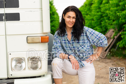 Woman is standing beside the truck