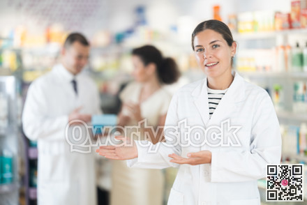 Female pharmacist in medical uniform posing while working in pharmacy