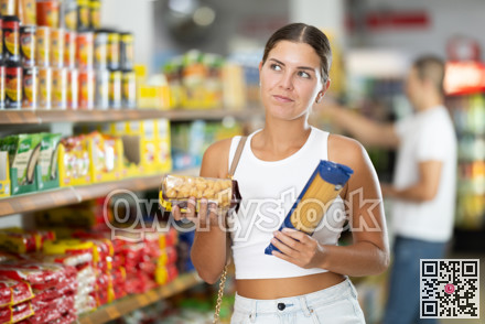 Girl buyer chooses between variation of noodles