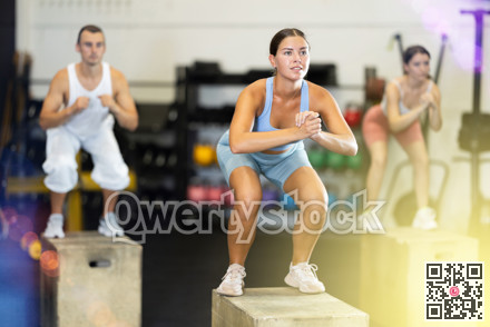 Woman doing muscle stretching. CrossFit in a group with other athletes