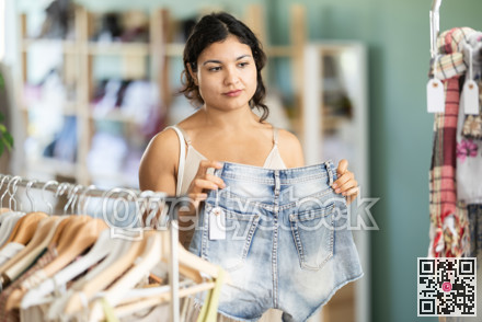 Girl at trading floor pick out and buying shorts