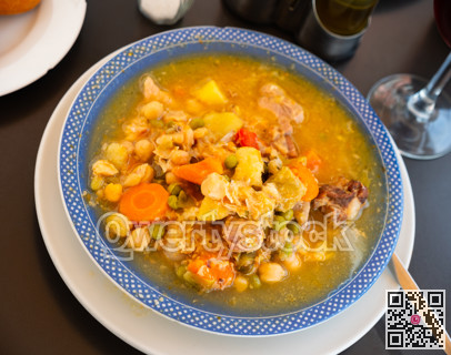 Plate with portion of hot chickpea and meat soup