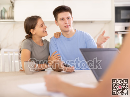 An insurance agent tells young couple the terms of property and life insurance