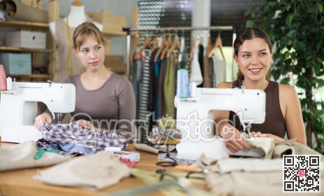 Two female tailors working in the workshop