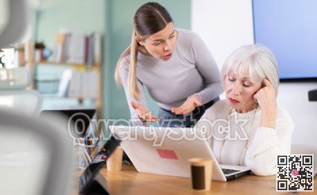 Female boss scolds an mature subordinate for errors in documents