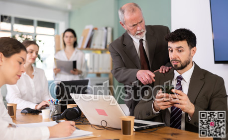 Mature man boss found man subordinate idling and scrolling phone, mentor shouts at subordinate.