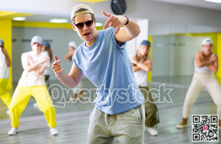 Young guy in sunglasses dancing modern dance