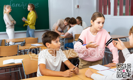 Schoolchilds working in groups at lesson