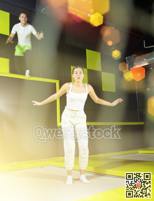Woman sportswoman fitness jumping on club trampoline