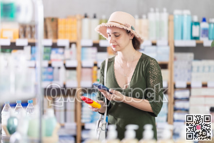 Woman in pharmacy scans QR code on mosquito repellent