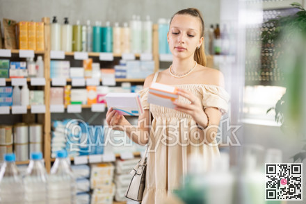 Girl in summer clothes looking for medicine in pharmacy