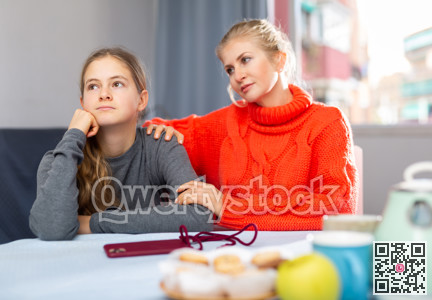 Portrait of woman trying to talk with daughter in home