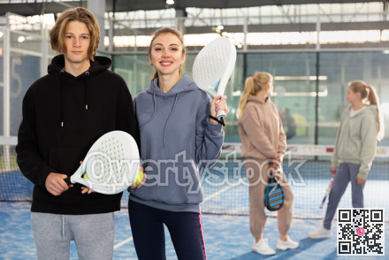 Teenage boy and young woman in padel court