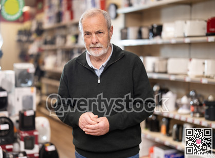 Senior man client looking for something in household appliance store.