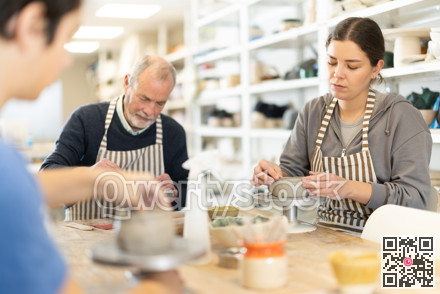 During working day, three pottery workshop workers sculpt from clay, form final product