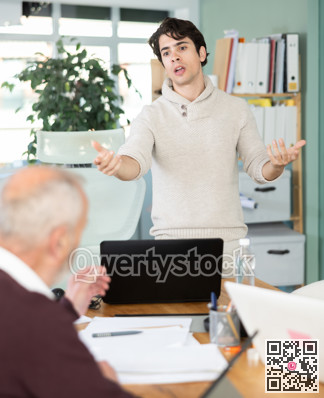 Guy head of department shouts at senior man subordinate who is working with documents
