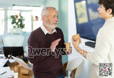 Male colleagues drink coffee and have nice conversation during break