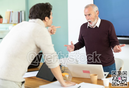 Elderly and young men arguing loudly in office