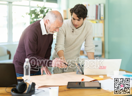 Engineer and architect discussing about blueprint layout design of electricity plan before construction in office