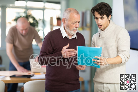 Colleagues businessmen business partners at office discuss financial data project documents paperwork