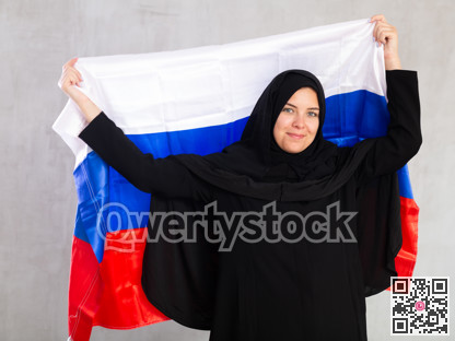 Balanced smiling Muslim woman in traditional black hijab holds flag of Russia
