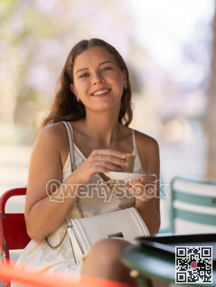 Young woman drinking coffee in cafe