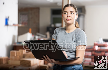 Young woman using laptop in house during renovating