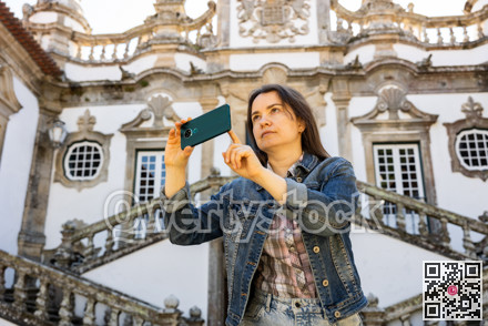 Woman tourist with phone, Vila Real, Portugal