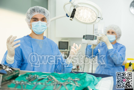 Young veterinarian in surgical attire standing in veterinary operating room