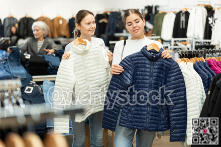 Young and adult women choosing jacket in store
