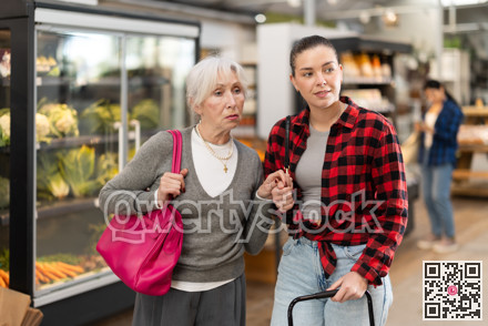 Family shopping at supermarket - choosing something in grocery section of supermarket