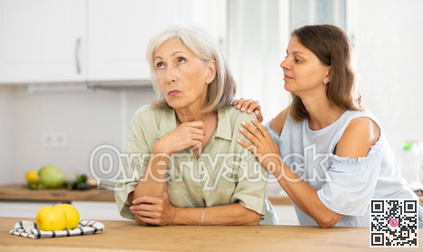 Apologetic adult daughter asking for forgiveness from her upset elderly mother after home disagreements