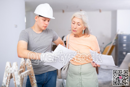 Teenager helping senior woman with home improvement works