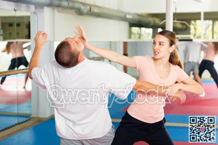 Girl practicing palm blow in chin in self defence training with coach