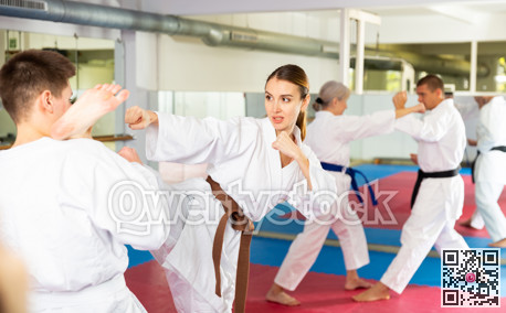 Woman sparring during group karate training