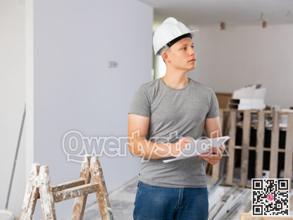 Young man checking project documentation in apartment during repair works