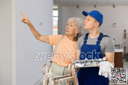Senior woman discussing work details with teenager boy in constrcuction site