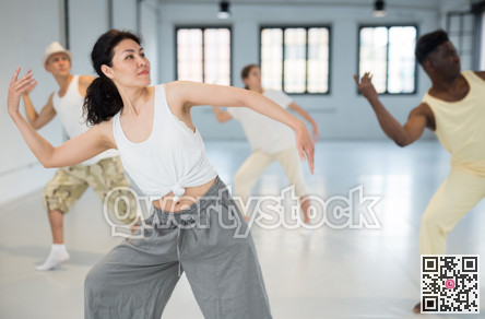 Asian woman studying movement of contemporary dance