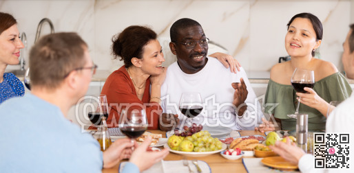 Multiethnic women and men friends chatting and drinking