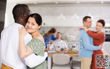 Happy middle-aged men and women doing slow dance in pairs