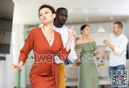Cheerful woman enjoying active dancing at friendly home gathering