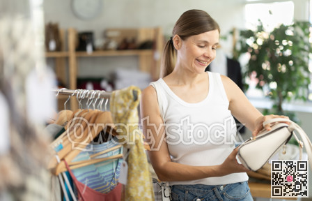 Adult women choosing handbag in store