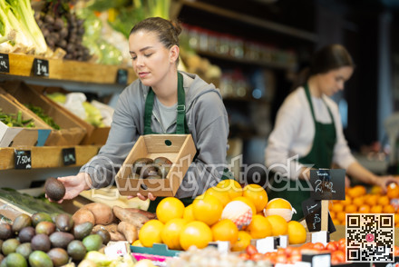 While working in shop, employee forms display case, puts avocado in pile