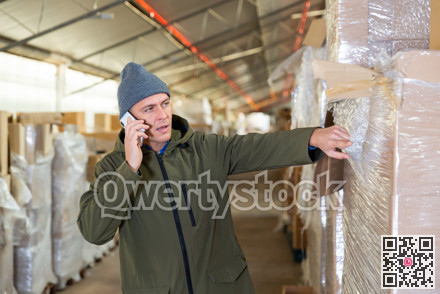 Warehouse worker talking on phone